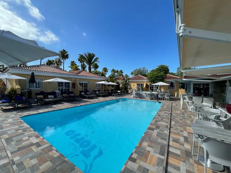 Heated saltwater pool with sun loungers at Club Torso, a small-scale men-only gay resort in Maspalomas, Gran Canaria